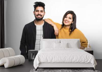 Portrait of beautiful young indian couple smiling isolated on white background Wall mural